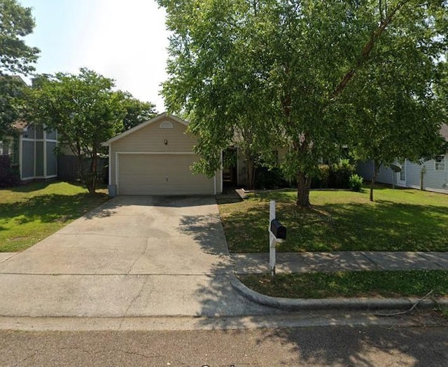 view of property hidden behind natural elements with a front lawn