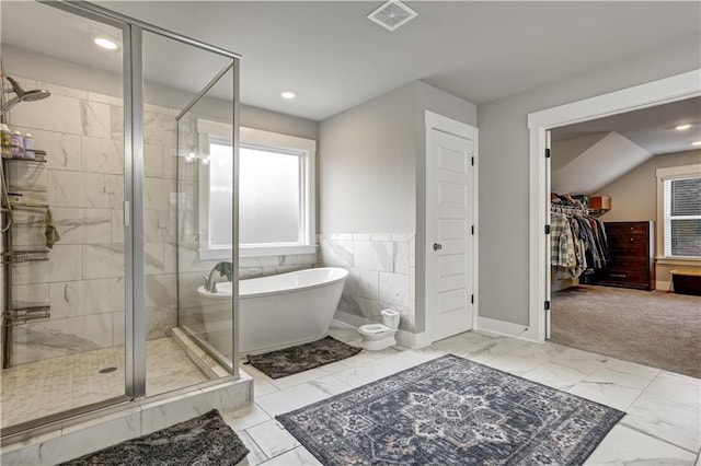 bathroom featuring shower with separate bathtub