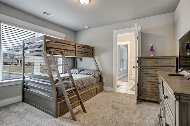 carpeted bedroom with multiple windows