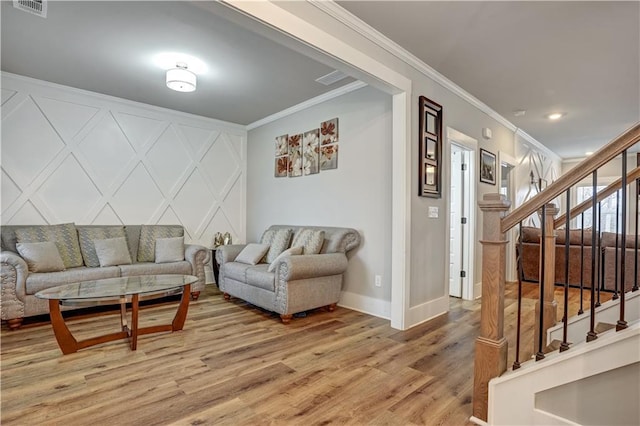 living room with crown molding and wood-type flooring