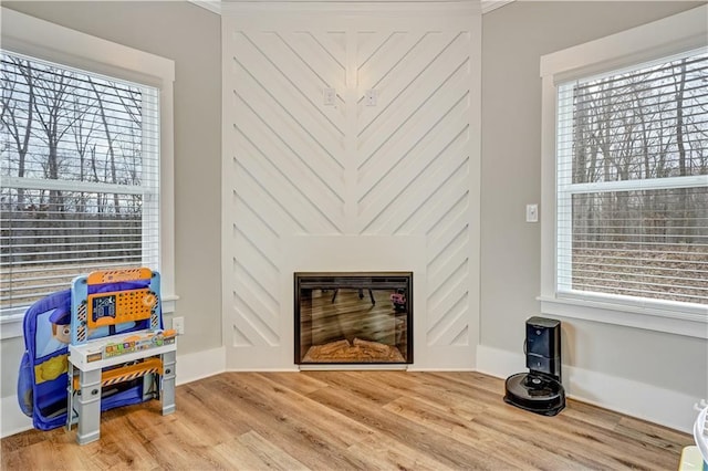 living room with hardwood / wood-style floors and ornamental molding