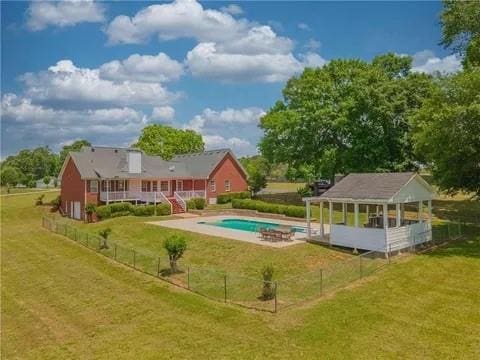 view of pool featuring a patio area and a yard