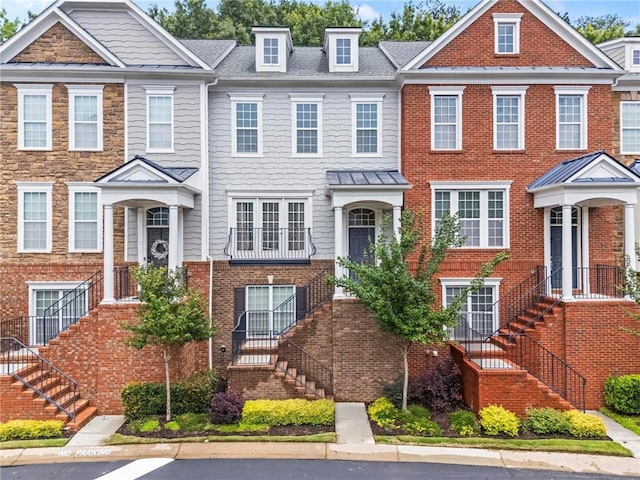 2343 Limehurst Dr NE, Atlanta, GA 30319 - view of property featuring stairway, a standing seam roof, and uncovered parking