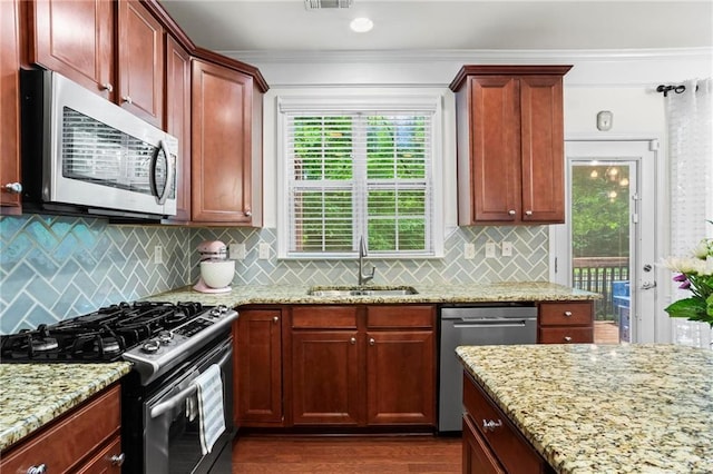 2343 Limehurst Dr NE, Atlanta, GA 30319 - kitchen featuring stainless steel appliances, light stone countertops, crown molding, dark wood-style flooring, and backsplash
