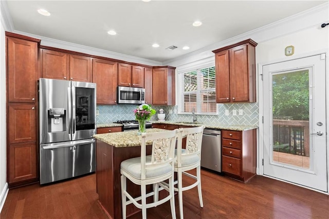 2343 Limehurst Dr NE, Atlanta, GA 30319 - kitchen featuring appliances with stainless steel finishes, dark wood-type flooring, backsplash, light stone counters, and ornamental molding