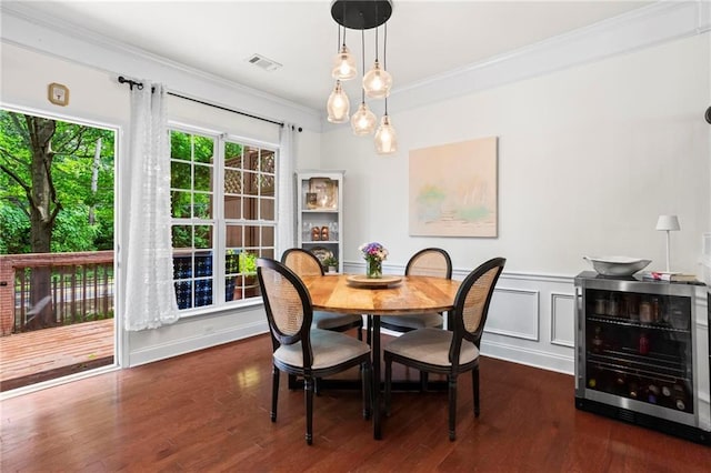 2343 Limehurst Dr NE, Atlanta, GA 30319 - dining room with beverage cooler, ornamental molding, wood finished floors, and a wainscoted wall