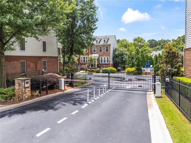 2343 Limehurst Dr NE, Atlanta, GA 30319 - view of asphalt street with a gate, curbs, and a gated entry