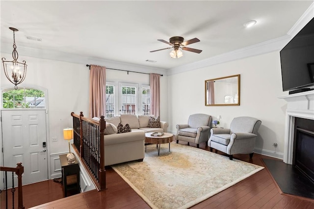 2343 Limehurst Dr NE, Atlanta, GA 30319 - living room featuring ceiling fan, dark wood-type flooring, a chandelier, a glass covered fireplace, and ornamental molding