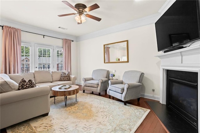 2343 Limehurst Dr NE, Atlanta, GA 30319 - living room with wood finished floors, a glass covered fireplace, crown molding, and ceiling fan