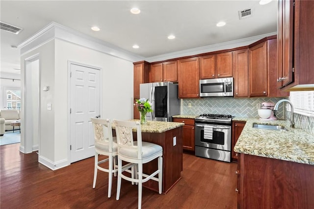 2343 Limehurst Dr NE, Atlanta, GA 30319 - kitchen with appliances with stainless steel finishes, dark wood-type flooring, tasteful backsplash, light stone counters, and ornamental molding