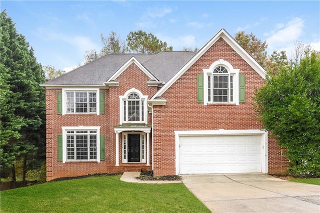 view of front facade with a garage and a front yard