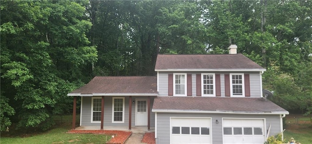 991 Park Creek Cir, Lawrenceville, GA 30044 - split level home with an attached garage, a chimney, a porch, driveway, and roof with shingles