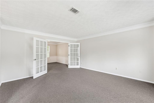spare room featuring baseboards, french doors, visible vents, and ornamental molding