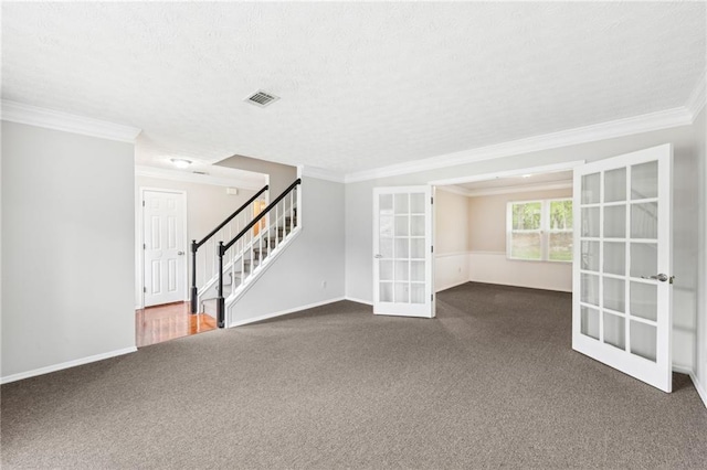 empty room featuring stairway, french doors, ornamental molding, dark colored carpet, and visible vents