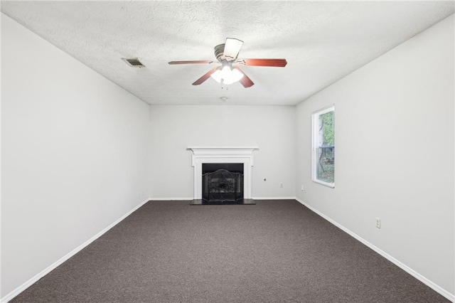 unfurnished living room with a fireplace with raised hearth, visible vents, a ceiling fan, and baseboards