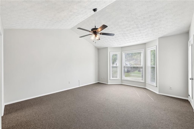 unfurnished room with dark colored carpet, baseboards, a textured ceiling, and ceiling fan