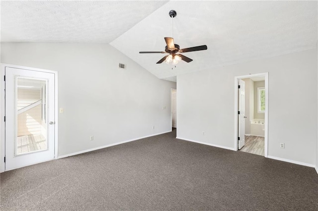 interior space with carpet, lofted ceiling, visible vents, connected bathroom, and baseboards