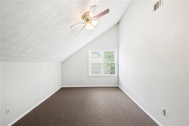bonus room featuring a ceiling fan, carpet floors, baseboards, lofted ceiling, and visible vents