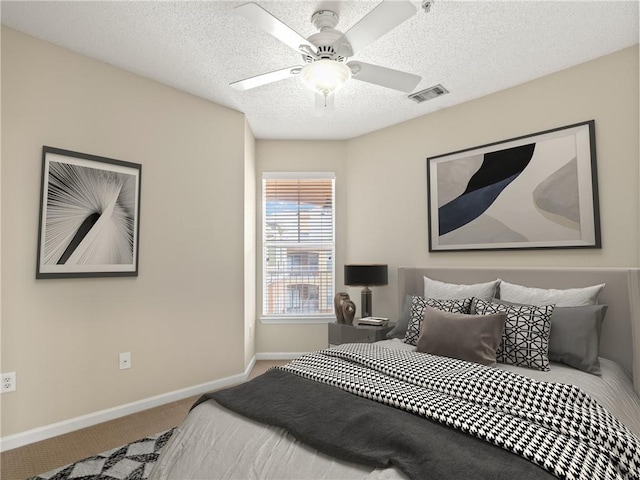 bedroom featuring a ceiling fan, baseboards, visible vents, carpet floors, and a textured ceiling