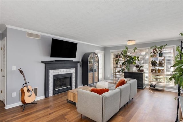 303 Gettysburg Pl, Atlanta, GA 30350 - living area with a brick fireplace, ornamental molding, wood finished floors, plenty of natural light, and baseboards