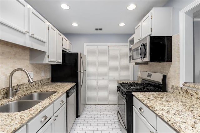 303 Gettysburg Pl, Atlanta, GA 30350 - kitchen with appliances with stainless steel finishes, a sink, decorative backsplash, white cabinets, and recessed lighting