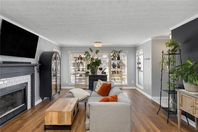303 Gettysburg Pl, Atlanta, GA 30350 - living area with a brick fireplace, wood finished floors, baseboards, a textured ceiling, and ornamental molding