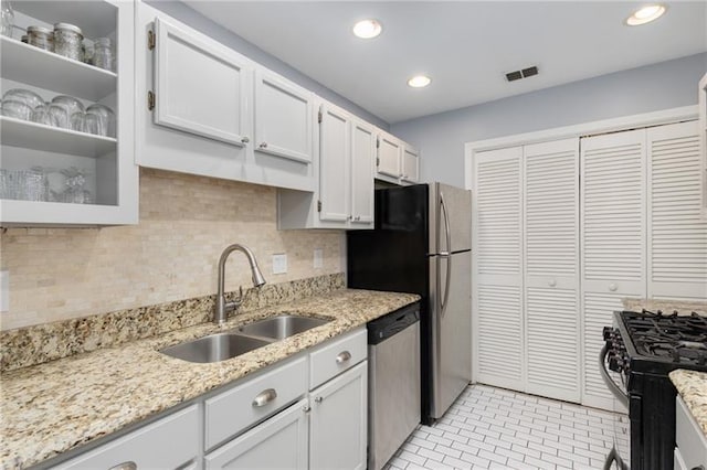 303 Gettysburg Pl, Atlanta, GA 30350 - kitchen featuring appliances with stainless steel finishes, a sink, decorative backsplash, light stone countertops, and recessed lighting