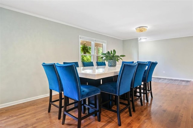 3415 Trickum Rd, Woodstock, GA 30188 - dining space with wood finished floors, ornamental molding, and baseboards