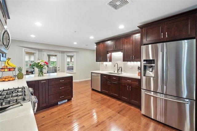 3415 Trickum Rd, Woodstock, GA 30188 - kitchen with appliances with stainless steel finishes, a sink, light countertops, dark brown cabinets, and recessed lighting