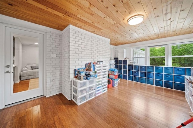 3415 Trickum Rd, Woodstock, GA 30188 - recreation room with wooden ceiling, wood finished floors, and brick wall