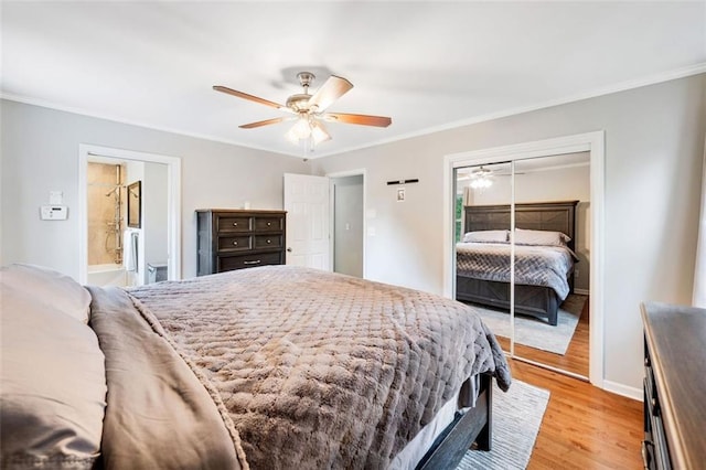 3415 Trickum Rd, Woodstock, GA 30188 - bedroom with ornamental molding, light wood finished floors, a ceiling fan, a closet, and baseboards
