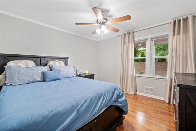 3415 Trickum Rd, Woodstock, GA 30188 - bedroom with light wood-type flooring, baseboards, crown molding, and a ceiling fan