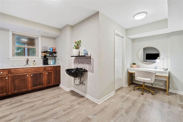 3415 Trickum Rd, Woodstock, GA 30188 - kitchen featuring light wood finished floors, a sink, light countertops, baseboards, and open shelves