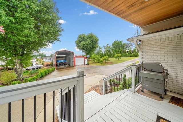 3415 Trickum Rd, Woodstock, GA 30188 - deck featuring area for grilling, a detached carport, and an outdoor structure