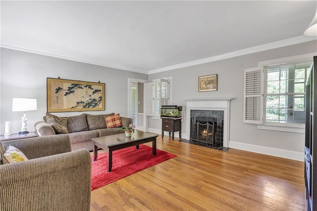 1908 E Roxboro Rd NE, Atlanta, GA 30324 - living room with a tiled fireplace, crown molding, and light wood-style flooring