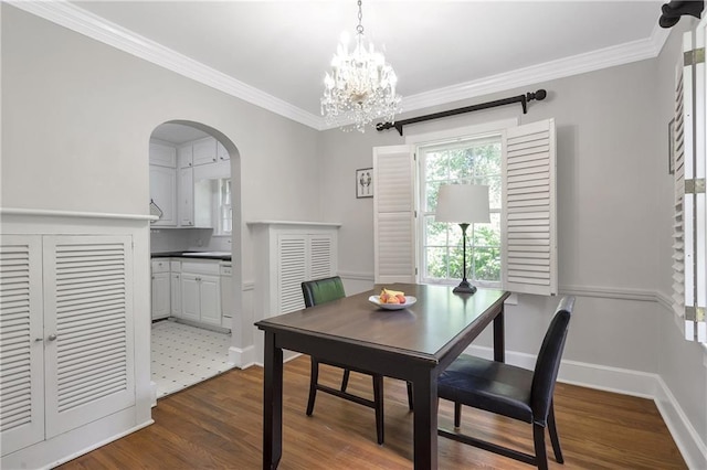 1908 E Roxboro Rd NE, Atlanta, GA 30324 - dining area with dark wood-style flooring, arched walkways, crown molding, and a chandelier