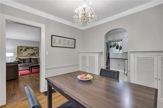 1908 E Roxboro Rd NE, Atlanta, GA 30324 - dining space with a chandelier, ornamental molding, arched walkways, and wood finished floors