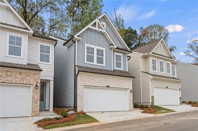 702 Smokey Quartz Way, Kennesaw, GA 30144 - view of front of home featuring board and batten siding, an attached garage, and brick siding