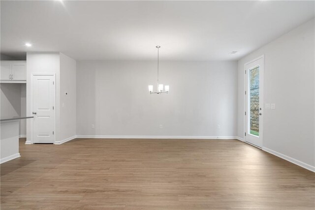 702 Smokey Quartz Way, Kennesaw, GA 30144 - unfurnished dining area with baseboards, light wood-style floors, recessed lighting, and a chandelier