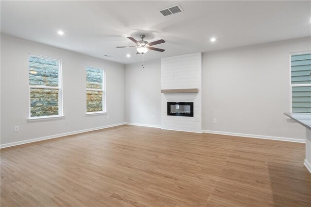 702 Smokey Quartz Way, Kennesaw, GA 30144 - unfurnished living room with a ceiling fan, recessed lighting, light wood-style floors, a fireplace, and baseboards