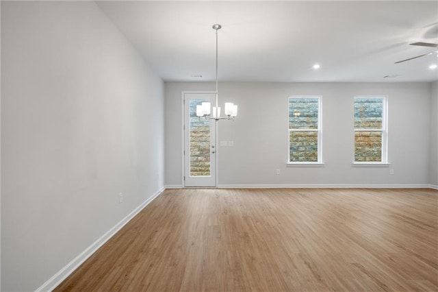 702 Smokey Quartz Way, Kennesaw, GA 30144 - unfurnished dining area with a chandelier, light wood-style flooring, and plenty of natural light