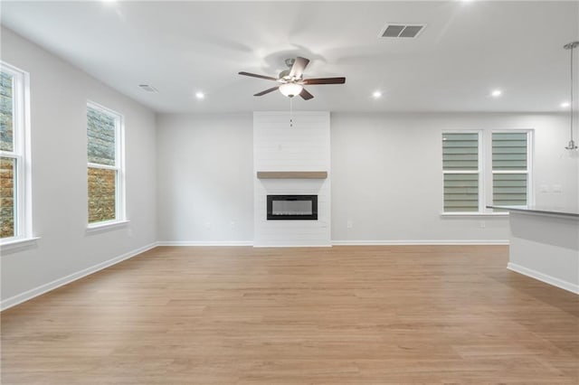 702 Smokey Quartz Way, Kennesaw, GA 30144 - unfurnished living room with ceiling fan, recessed lighting, light wood-style floors, baseboards, and a fireplace