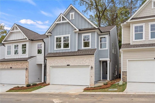 702 Smokey Quartz Way, Kennesaw, GA 30144 - view of front facade with board and batten siding, a garage, a shingled roof, and concrete driveway