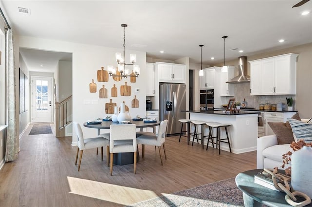 702 Smokey Quartz Way, Kennesaw, GA 30144 - dining space featuring light wood finished floors, recessed lighting, a chandelier, stairs, and baseboards
