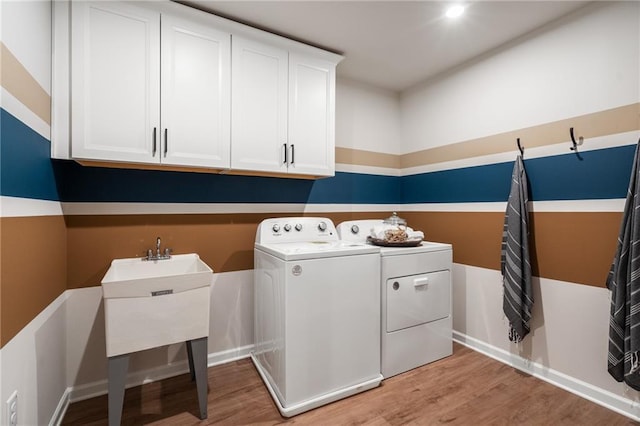 702 Smokey Quartz Way, Kennesaw, GA 30144 - washroom featuring washer and dryer, cabinet space, light wood finished floors, and baseboards