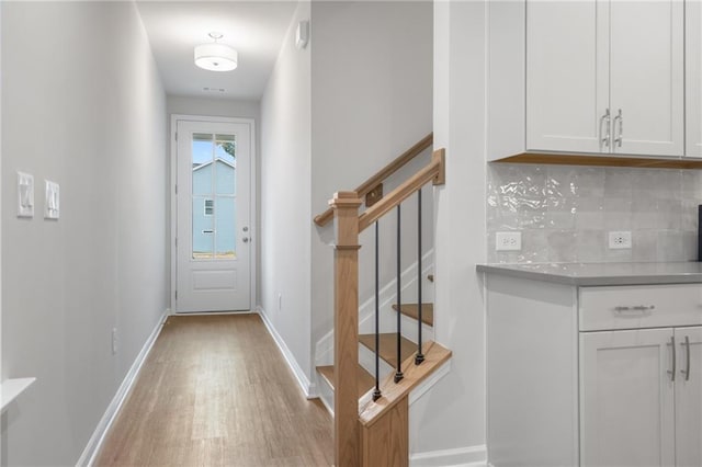702 Smokey Quartz Way, Kennesaw, GA 30144 - doorway to outside featuring light wood-style flooring, stairs, and baseboards