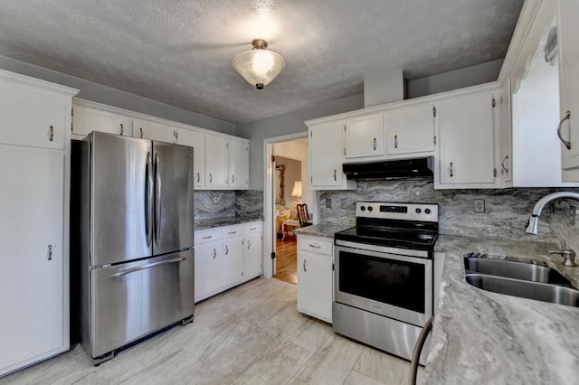 kitchen featuring decorative backsplash, stainless steel appliances, under cabinet range hood, white cabinetry, and a sink