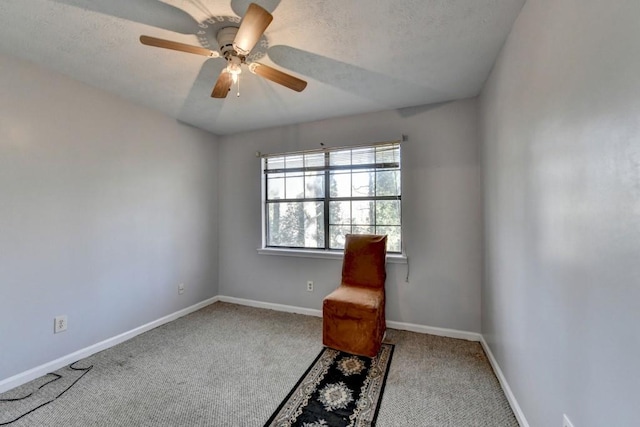 unfurnished room with carpet flooring, ceiling fan, a textured ceiling, and baseboards