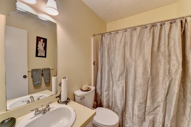 bathroom featuring vanity, toilet, and a shower with curtain