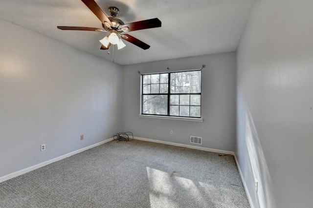 unfurnished room with a ceiling fan, baseboards, visible vents, and carpet flooring